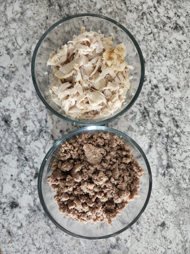 Prepped chicken breast and lean ground beef on counter